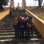 group poses on steps leading up to a church